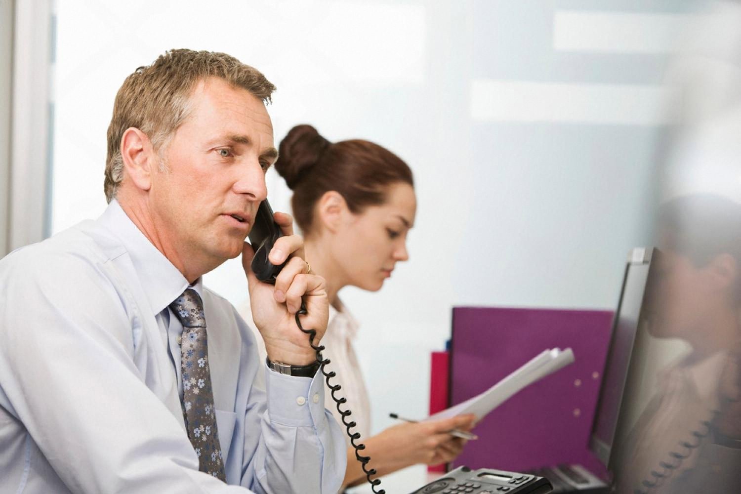 IT support staff answering a business call in a Dubai office