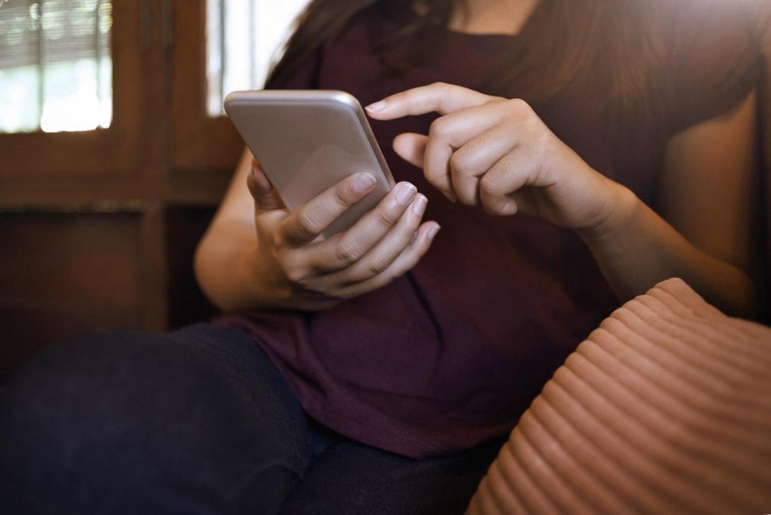 Person checking a company profile on a smartphone at home